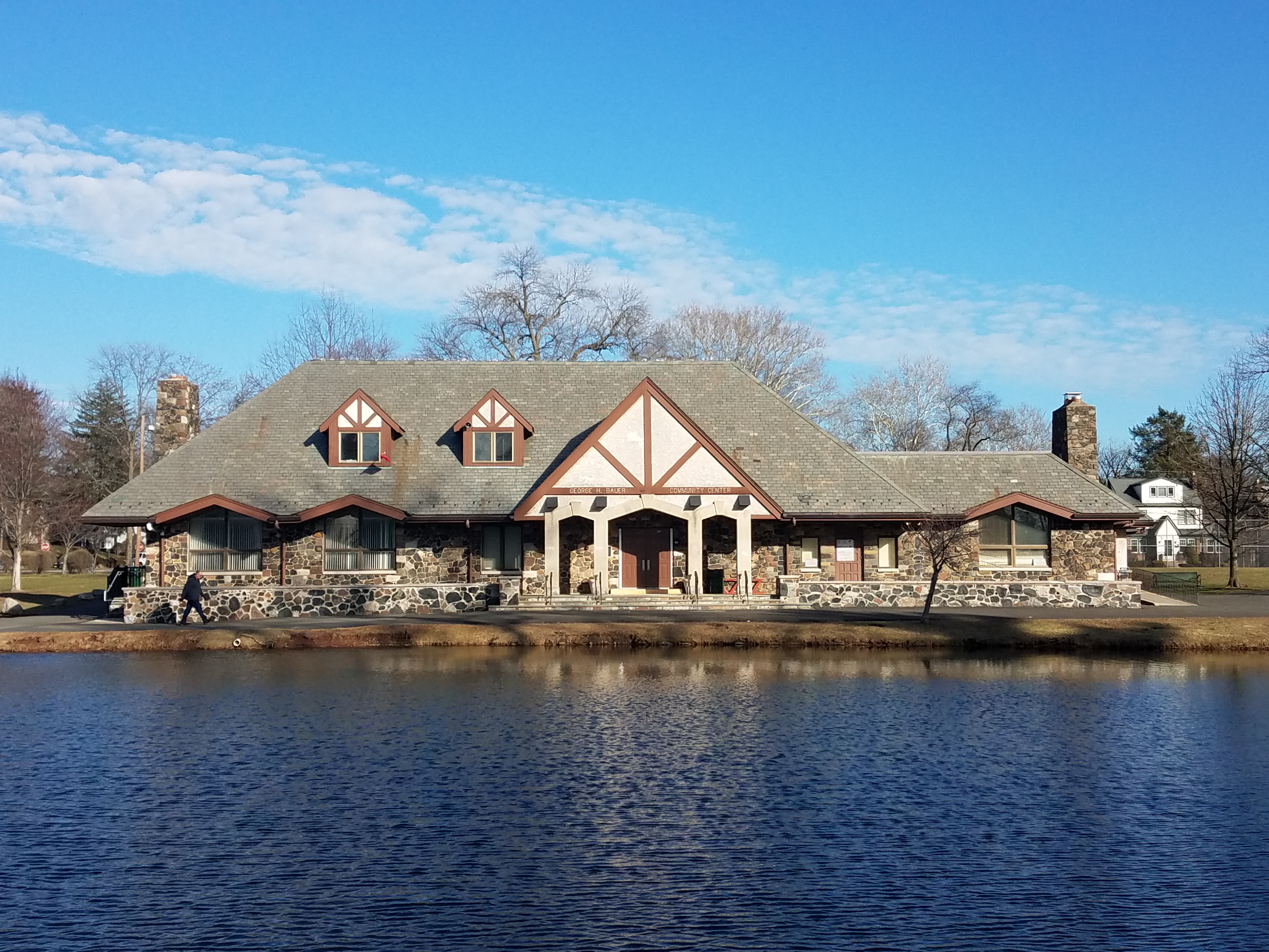 Photo of Taylor Park Community Center in Millburn Township showing open space that contains, green grass with mature trees, walking paths, pond, and a peaceful atmosphere, highlighting the township’s abundant natural beauty and recreational opportunities.