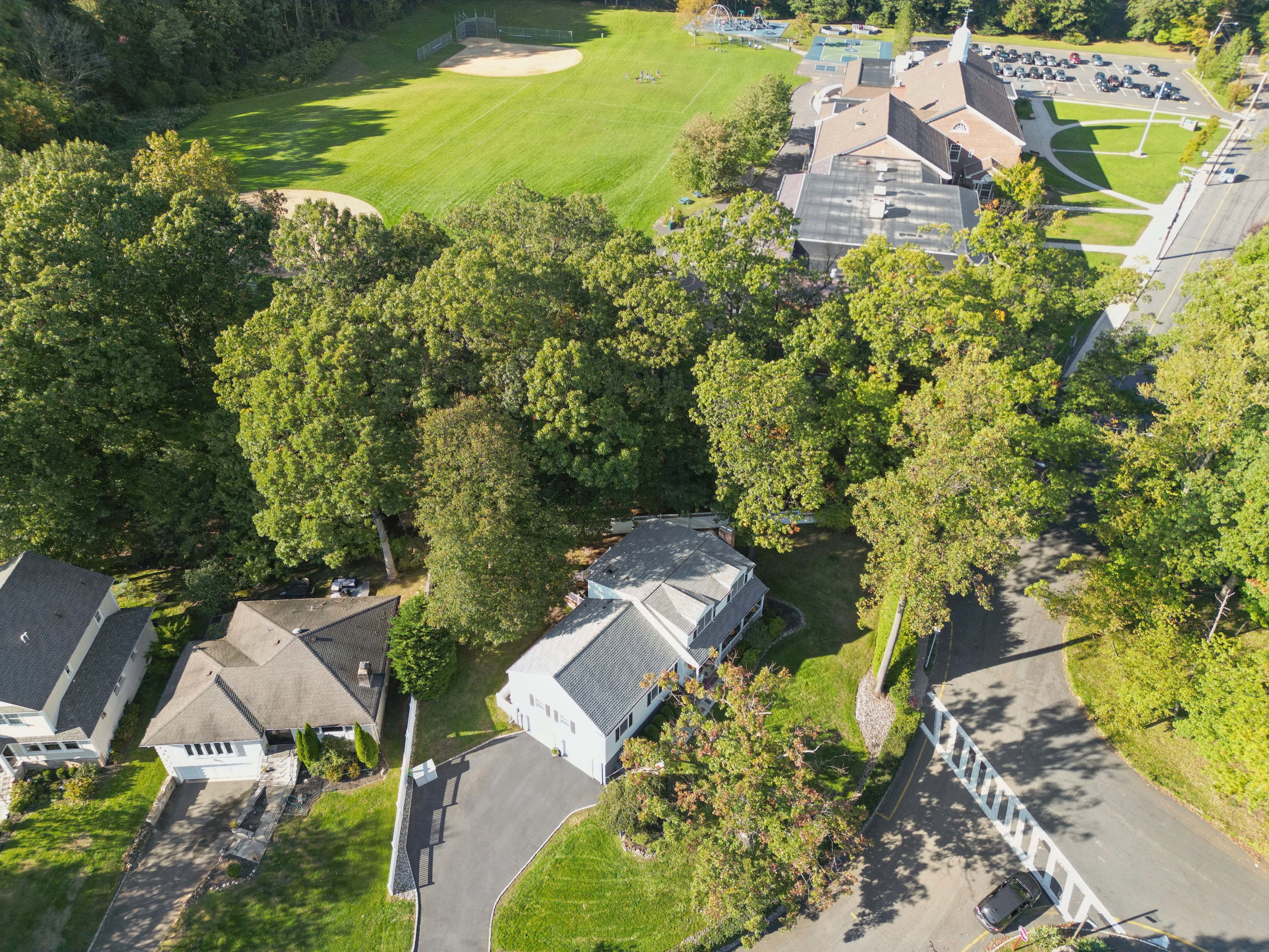 Aerial view of a vibrant New Jersey neighborhood showcasing a variety of well-maintained homes, illustrating the diverse real estate opportunities available through LuxeLife Group led by Simon and John Westfall-Kwong.