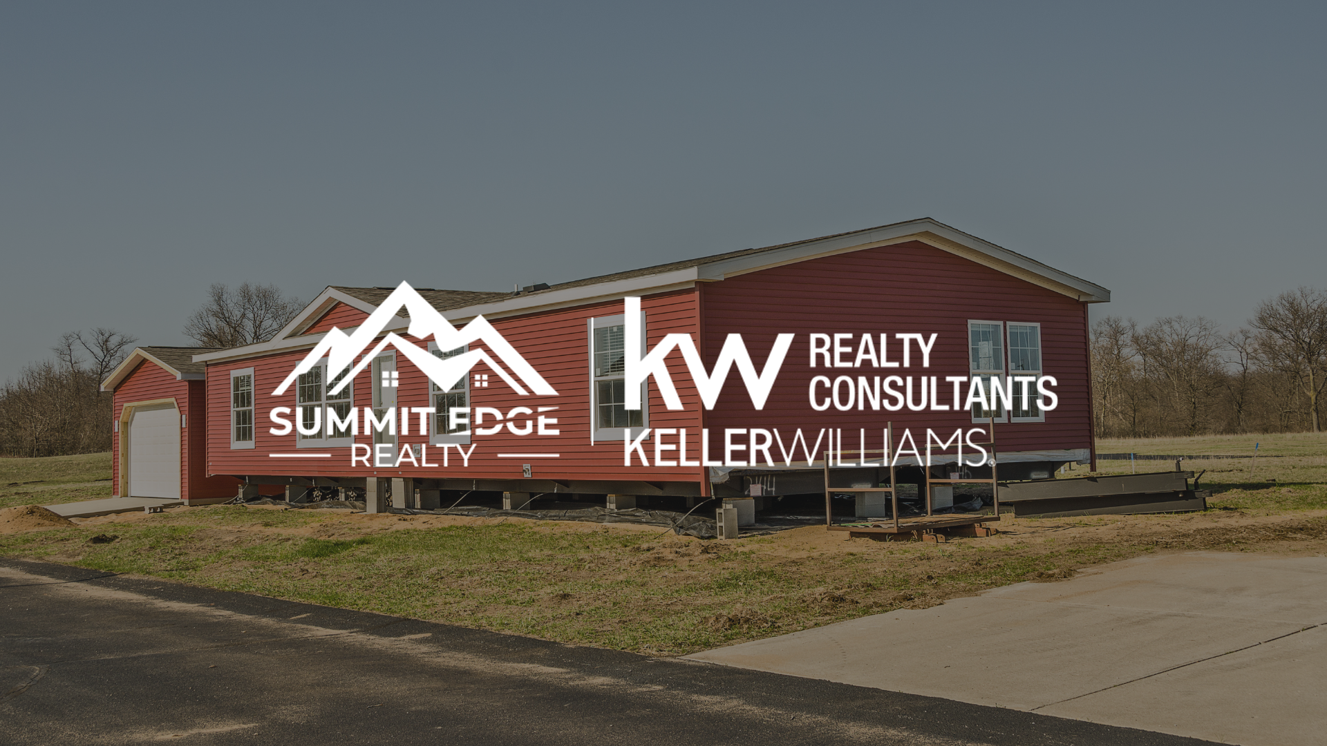 A red manufactured home in Clark County, IN, with a small porch and attached garage, set on a green lot with a paved driveway, surrounded by trees under a cloudy sky, overlaid with the Summit Edge Realty and KW Realty Consultants Keller Williams logo in white text.
