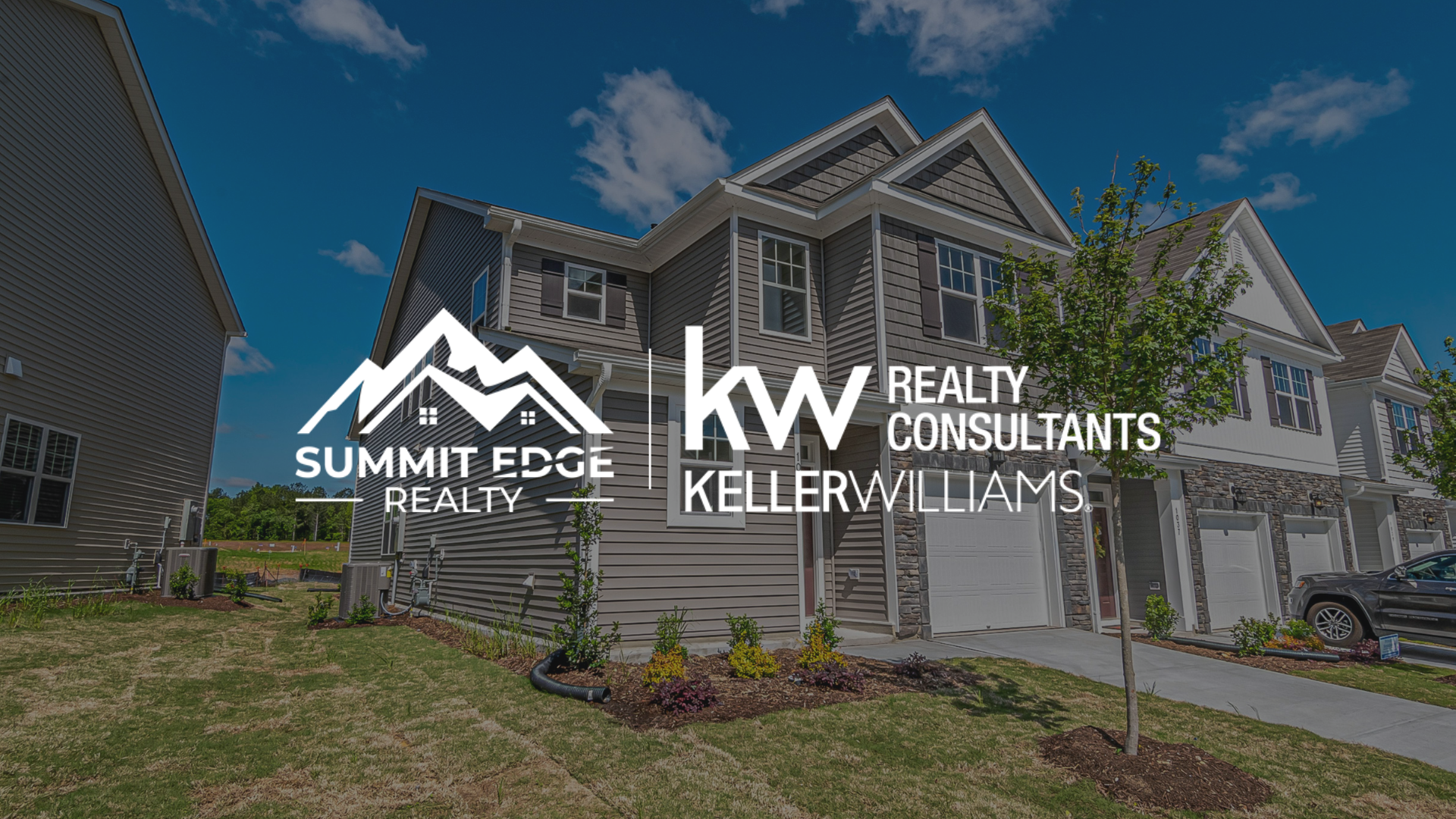 Exterior view of a luxury multifamily house located in Floyd County, IN, with the Summit Edge Realty logo in the foreground.