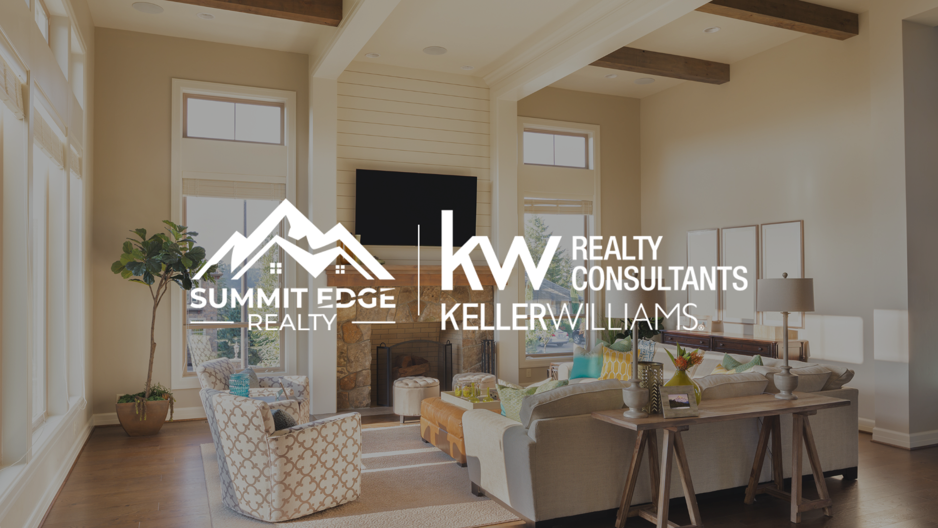 Image of a well-decorated living room with large windows, a stone fireplace, and a potted plant, with the Summit Edge Realty and Keller Williams Realty Consultants logo prominently placed in the foreground.
