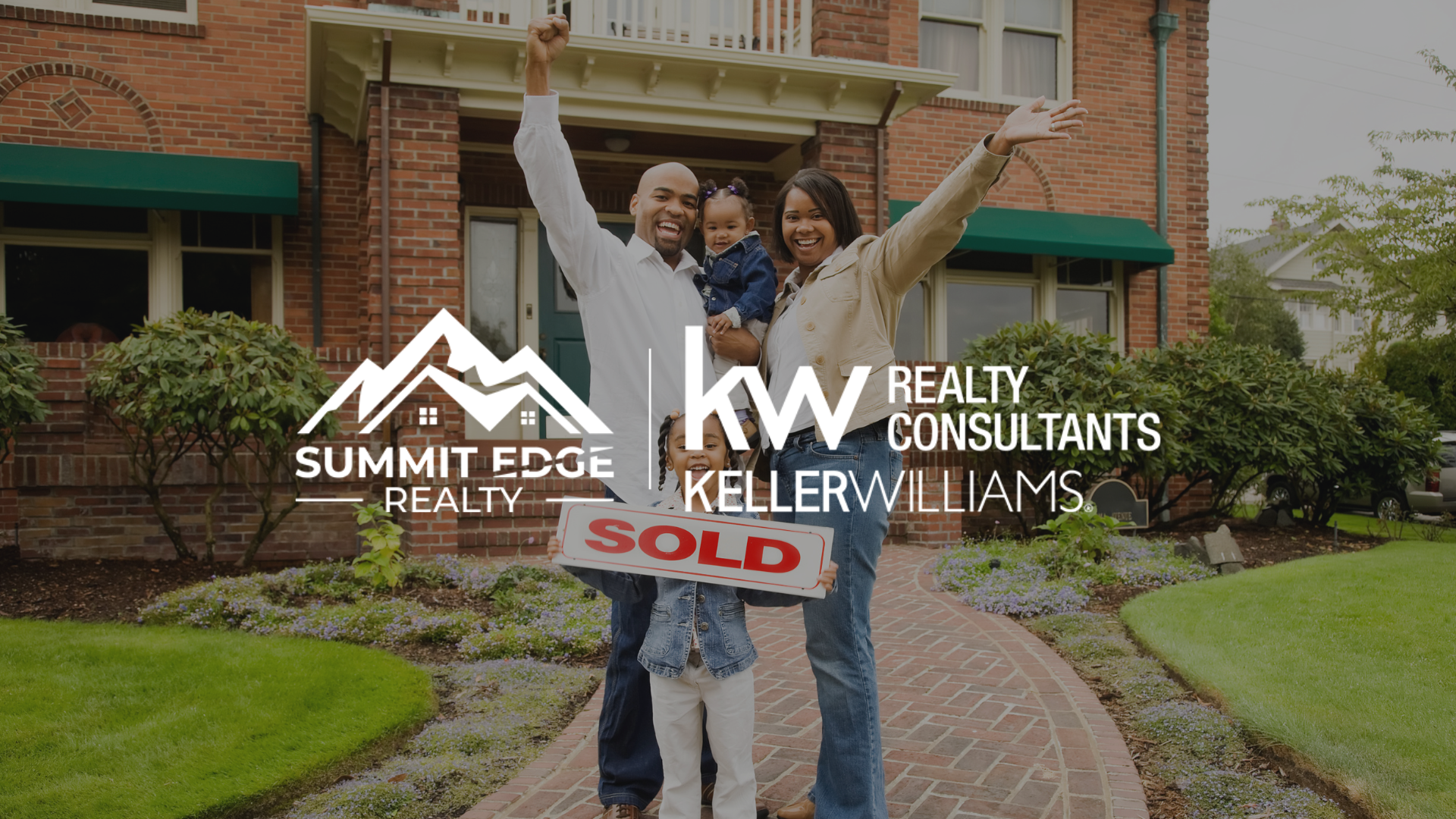 A family celebrating in front of a brick single family home holding a "SOLD" sign, featuring the Summit Edge Realty and Keller Williams Realty Consultants logo in the foreground.