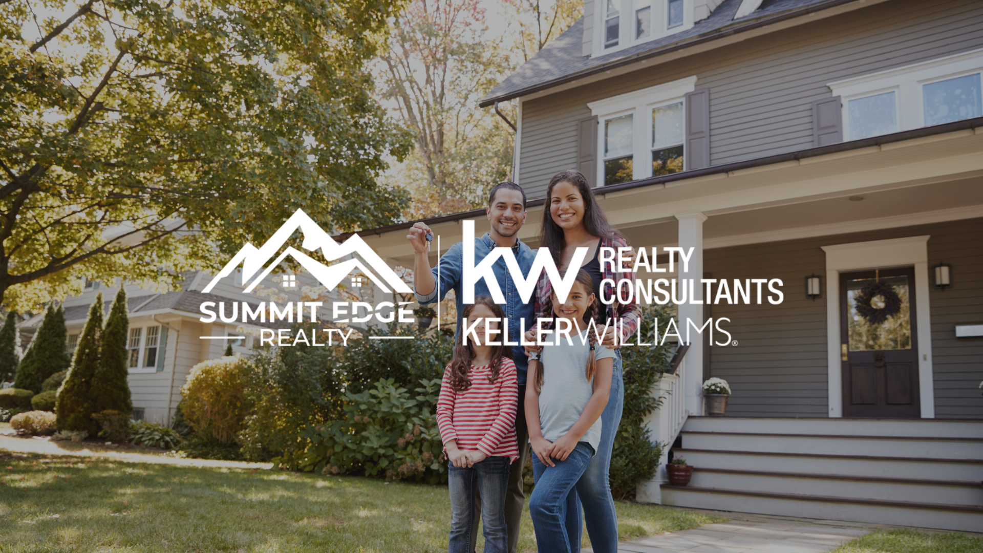 A suburban single family home with a gray exterior and porch, with a happy family holding keys, accompanied by the Summit Edge Realty and Keller Williams Realty Consultants logo in white.