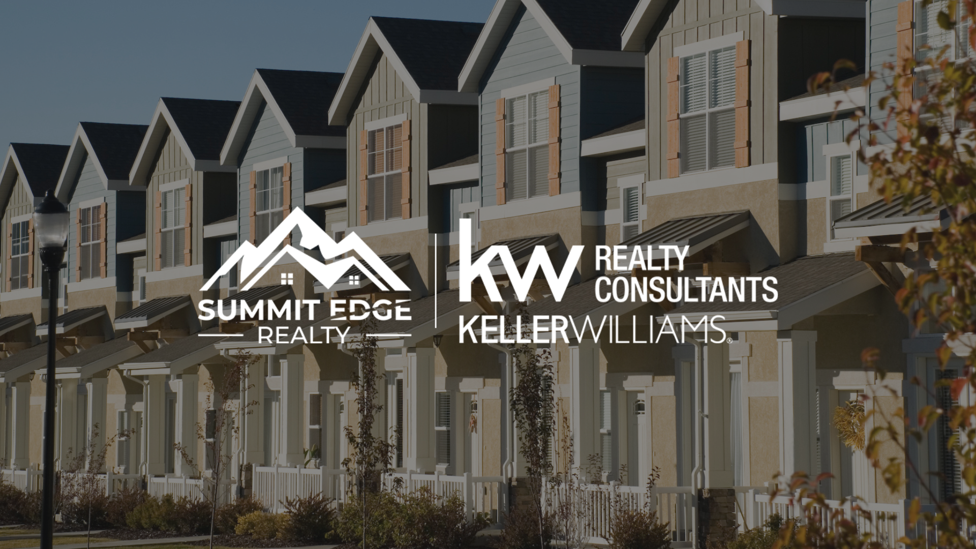 Exterior of townhouse style condos with the Summit Edge Realty logo in foreground
