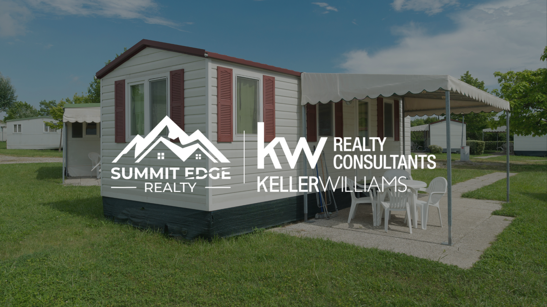 A charming manufactured home in Louisville, KY, with a white exterior, red shutters, and a covered porch with white chairs, set on a lush green lawn under a clear blue sky, overlaid with the Summit Edge Realty and KW Realty Consultants Keller Williams logo in white text.
