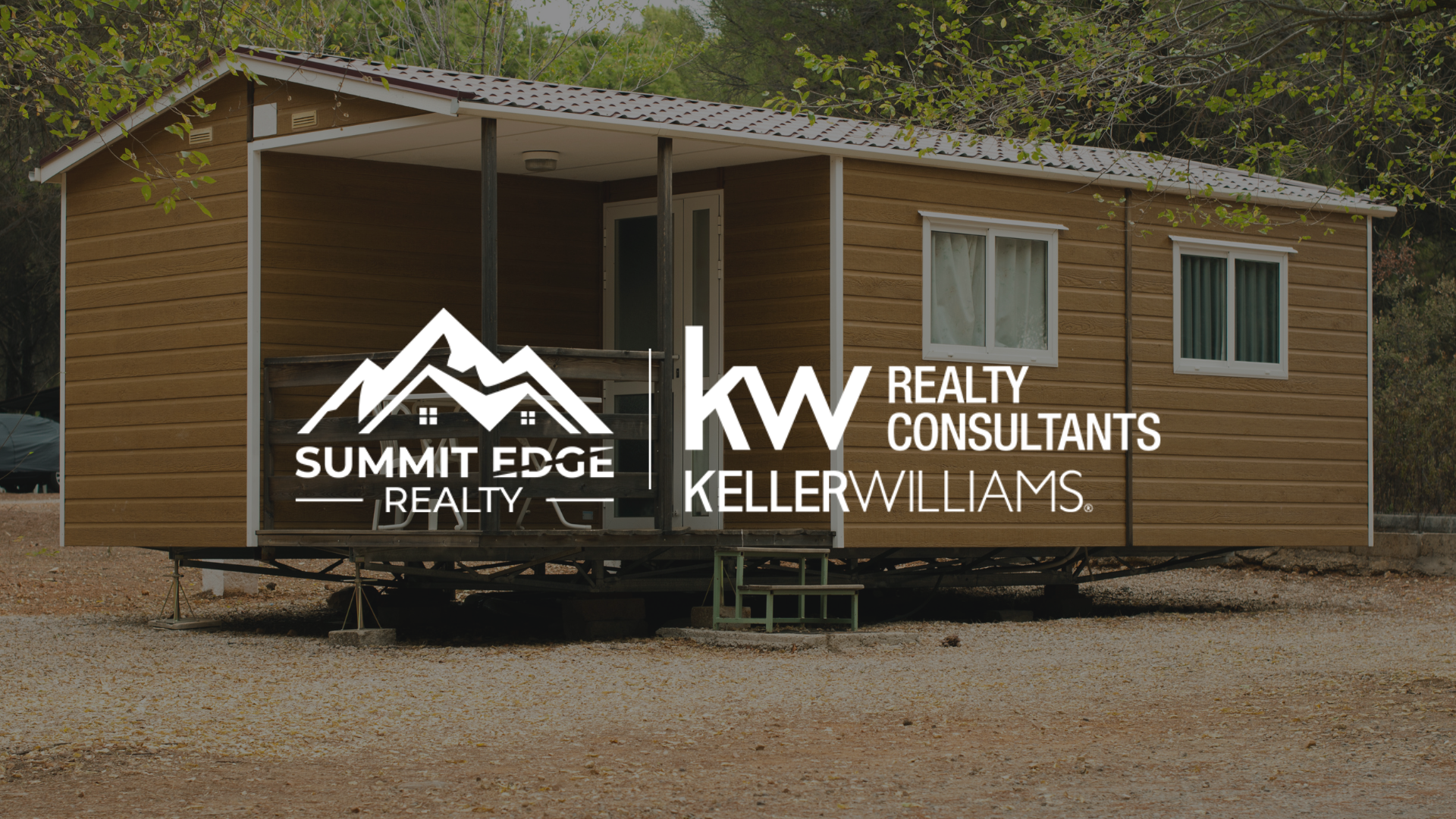 A Louisville, KY, manufactured residence with a brown exterior, a covered porch with wooden supports, and large windows, set on a gravel lot with trees in the background under a clear sky, overlaid with the Summit Edge Realty and KW Realty Consultants Keller Williams logo in white.