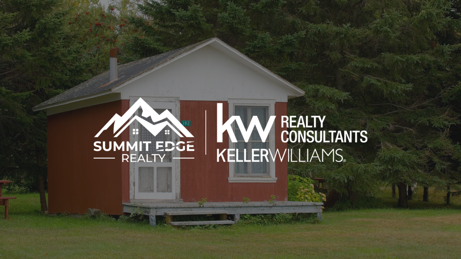 A charming tiny home in Clark County, IN, with a red exterior, white trim, and a small porch, set on a lush green lawn surrounded by tall pine trees under a cloudy sky, overlaid with the Summit Edge Realty and KW Realty Consultants Keller Williams logo in white text.