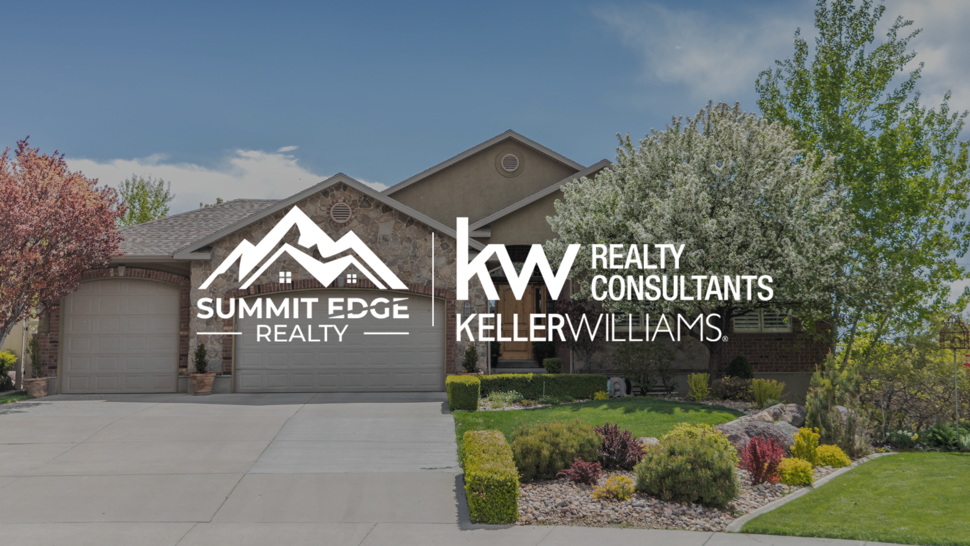 Front view of a modern single family home with a stone facade, double garage, and colorful shrubs, overlaid with the Summit Edge Realty and Keller Williams Realty Consultants branding in white text.