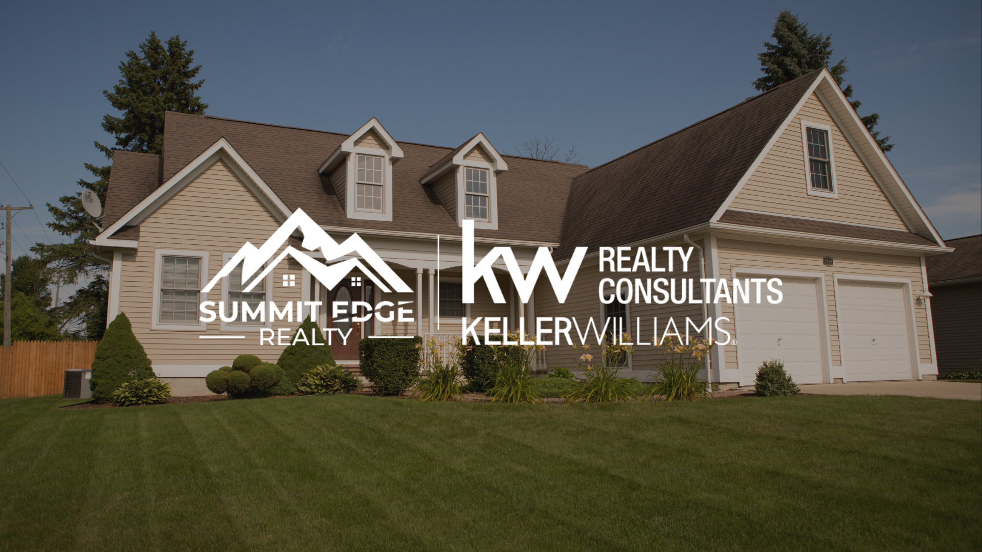 A suburban single family home with a beige exterior, double garage, and neatly trimmed bushes, accompanied by the Summit Edge Realty and Keller Williams Realty Consultants logo in white.