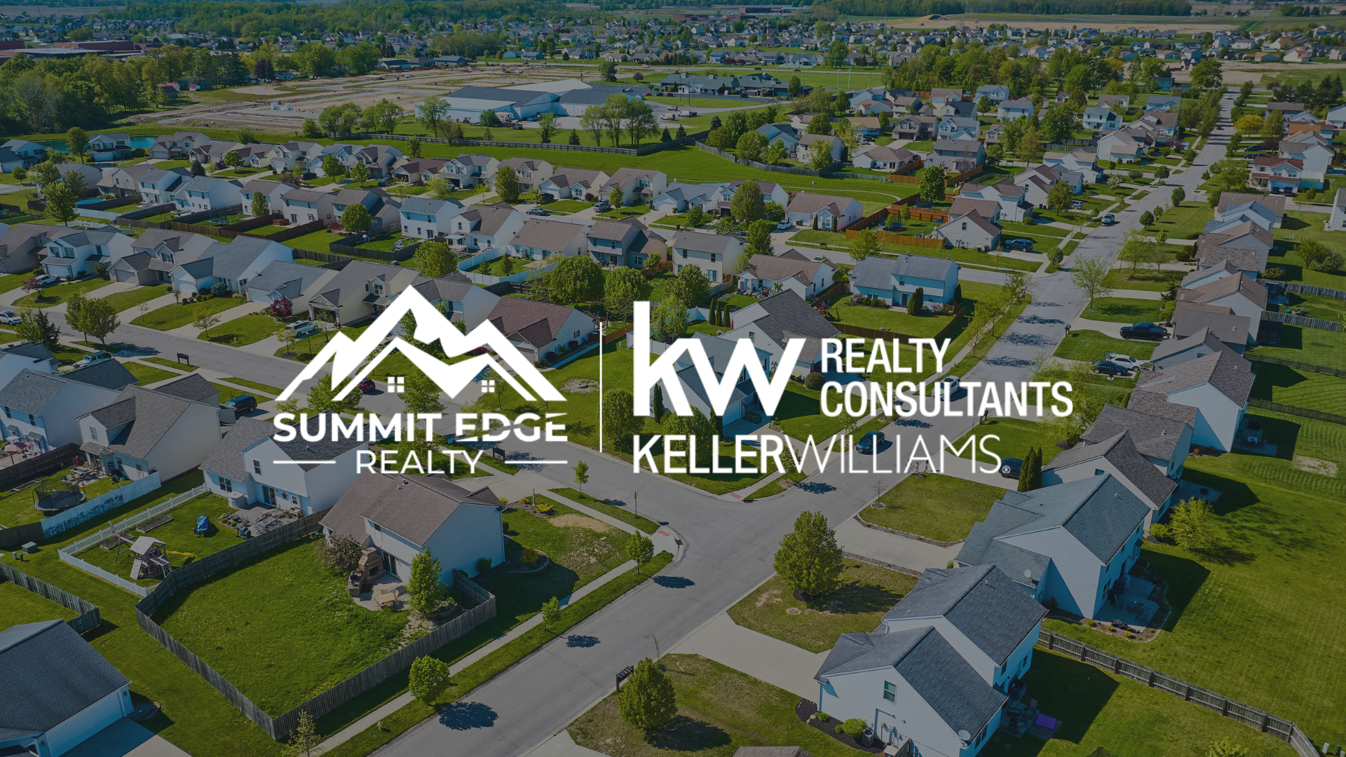 Aerial view of an Indiana suburban neighborhood with single family homes, featuring the Summit Edge Realty and Keller Williams Realty Consultants logo in the foreground.