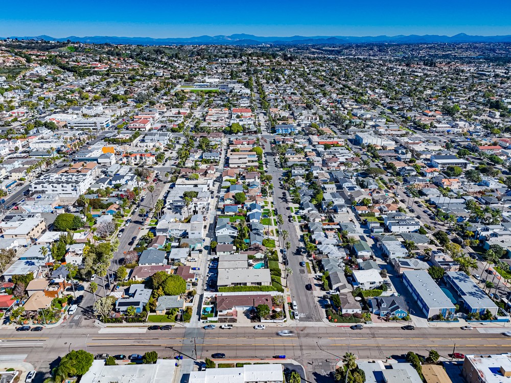 aerial photo of home in pacific beach with roads and blue sky