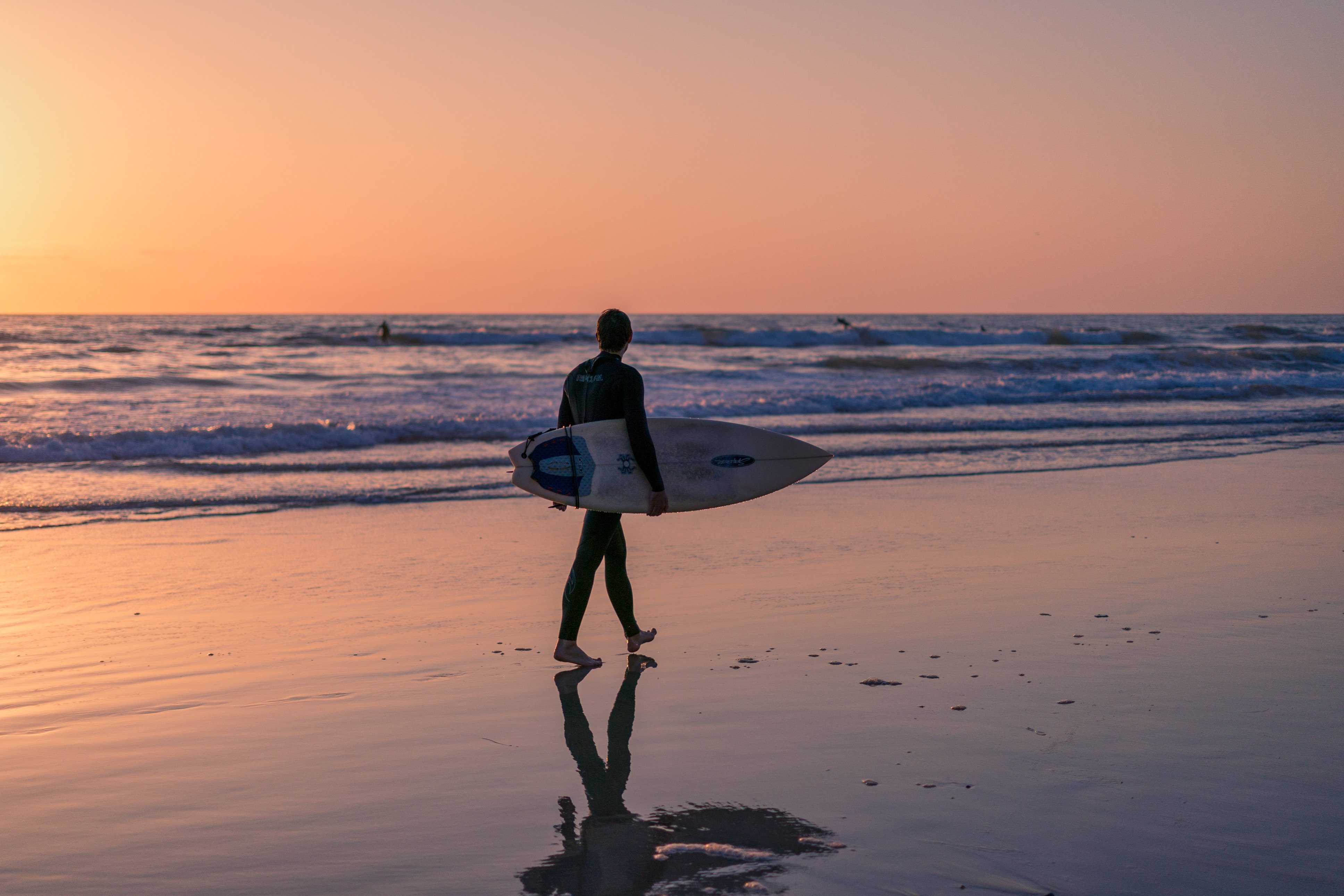 Surfer on beach in San Diego