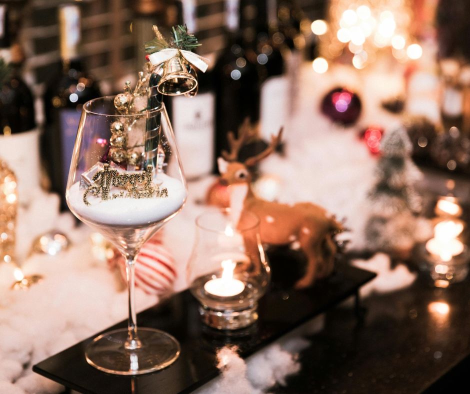 A beautifully set holiday dining table with warm lighting, cloth napkins, elegant place settings, seasonal greenery, and a welcoming centerpiece — creating an inviting atmosphere perfect for festive hosting.