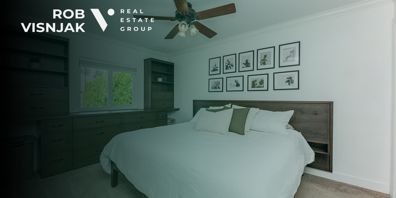 Bedroom with a ceiling fan and built-in shelving in a Langley rancher