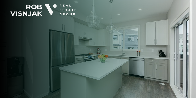 Kitchen with a white island and stainless steel appliances in a Surrey townhome