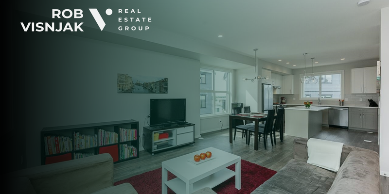 Open living and dining area with a red rug in a Surrey townhome