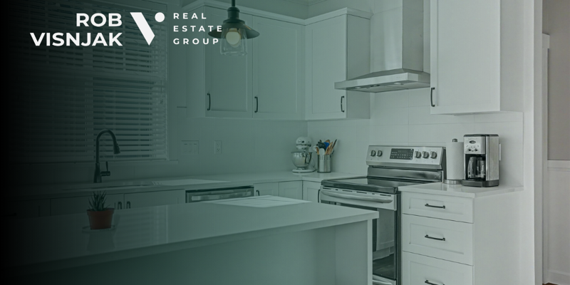 White kitchen with island in a Langley family home