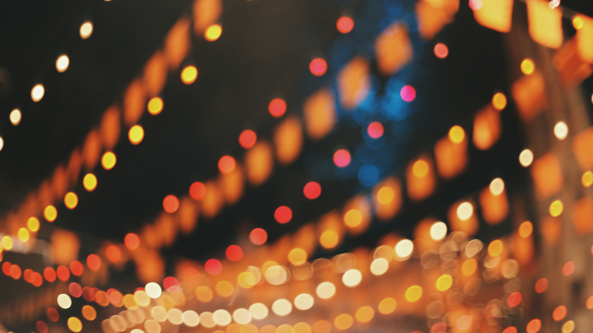 Blurred colorful string lights creating a warm, festive bokeh background