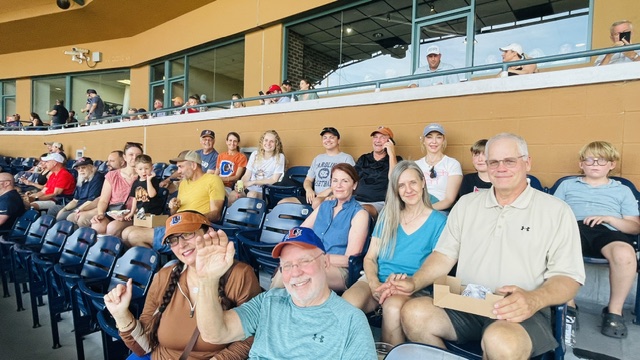 people waving in baseball stands