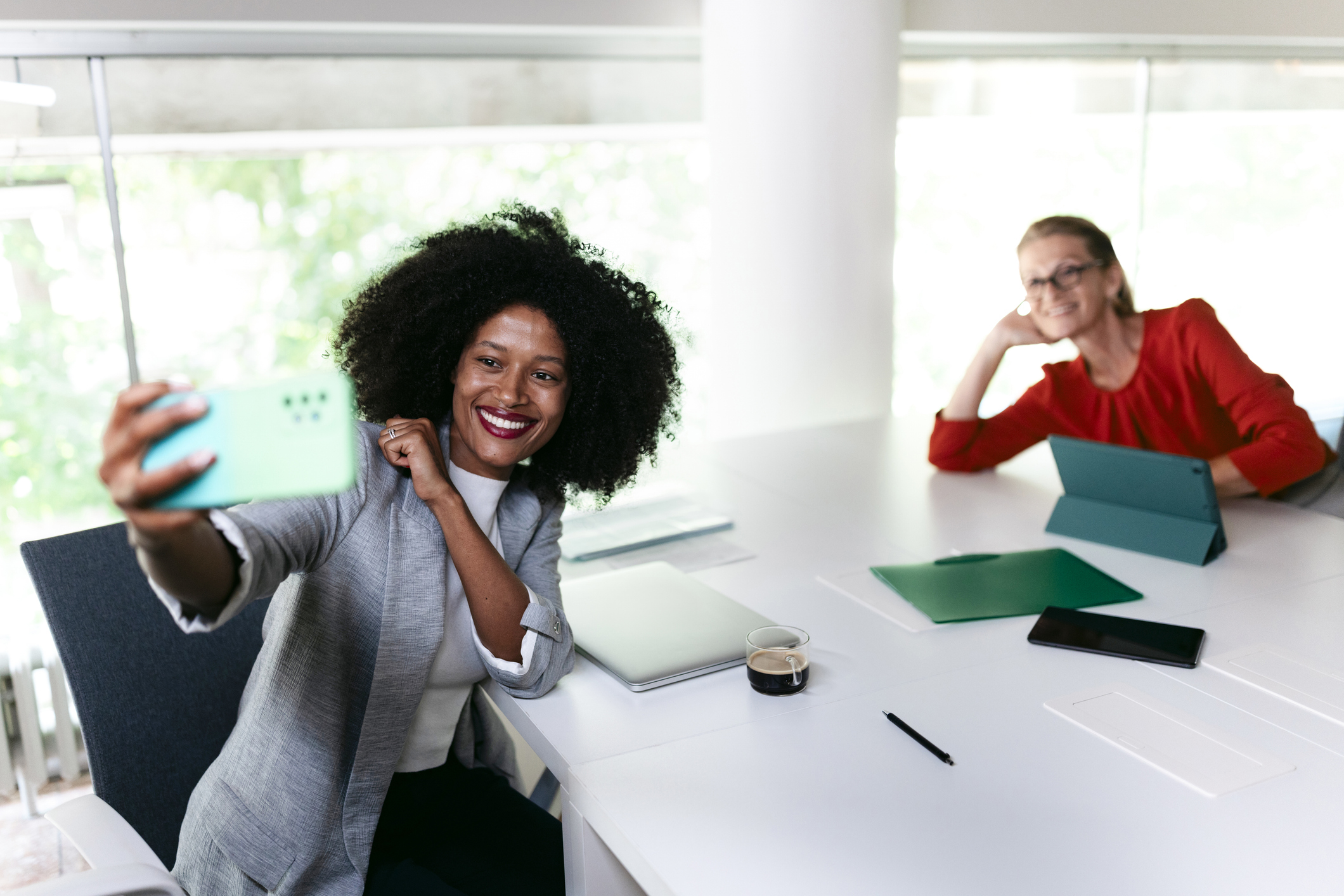 Bright, clean team workspace or outdoor meeting setting — warm tones, natural light, collaborative energy. Think Maine charm meets professional confidence.