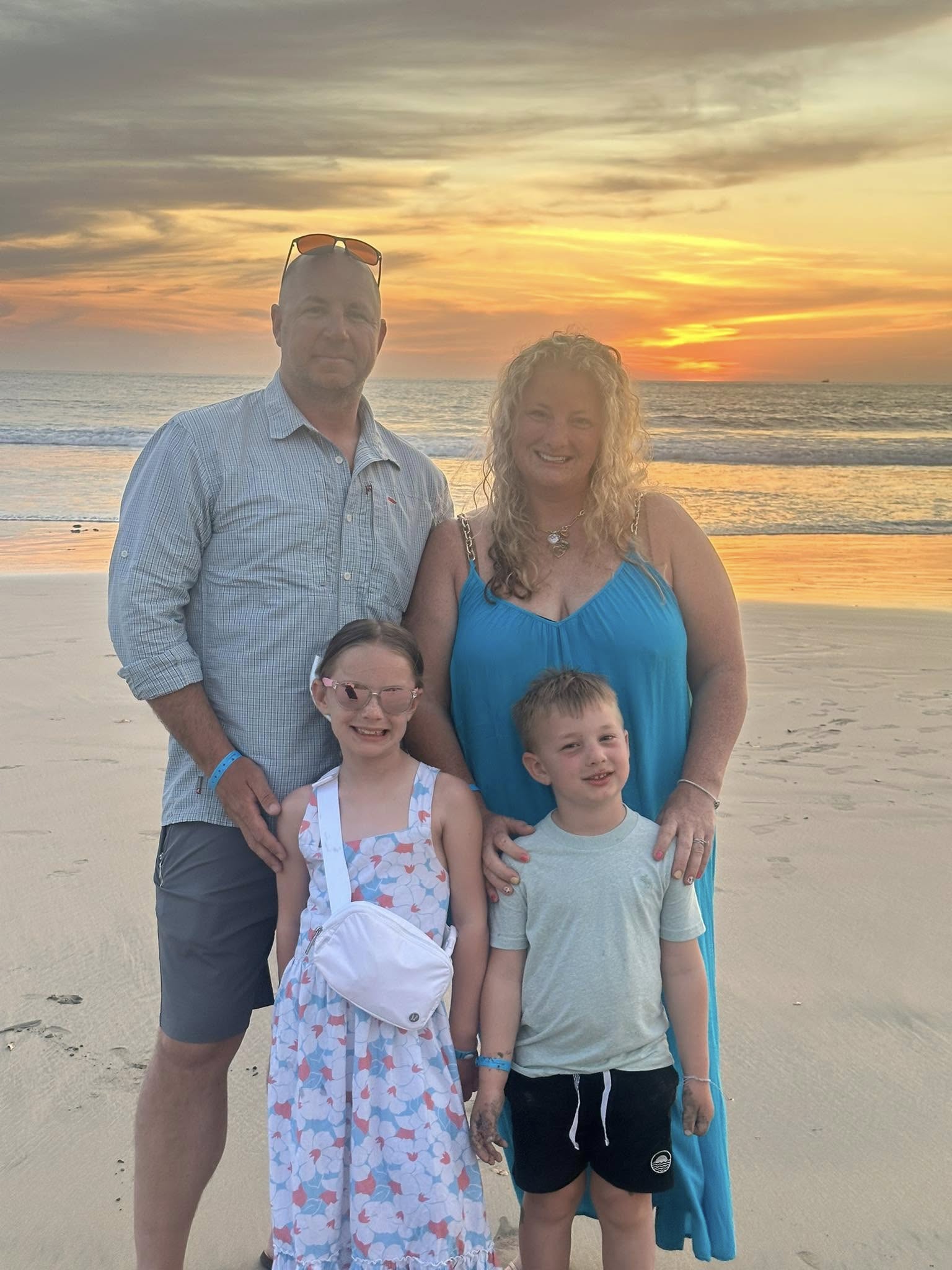 family on the beach at sunset