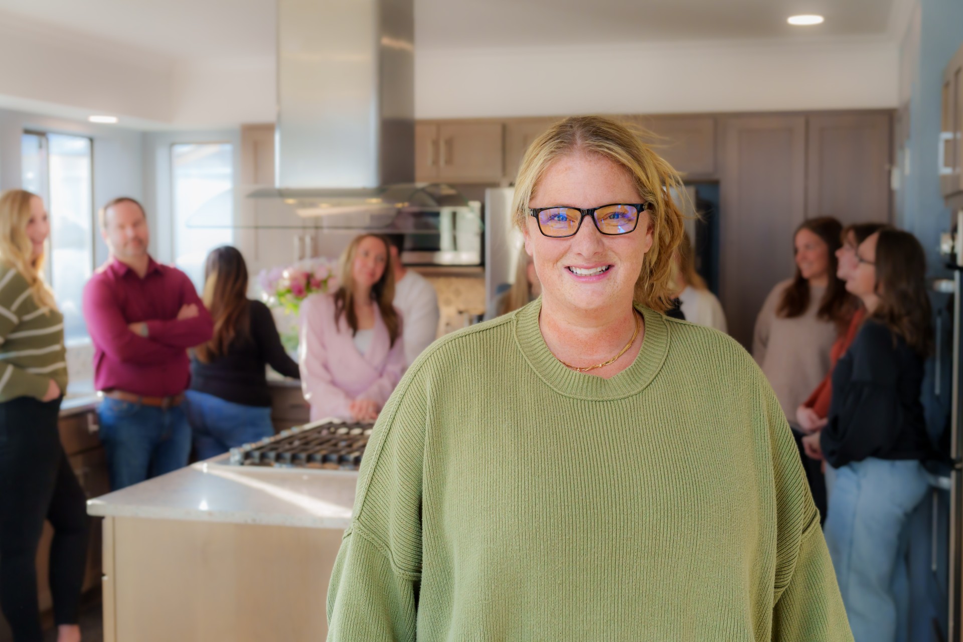 woman in green with people behind her 